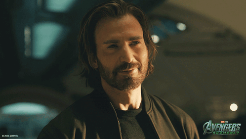 Long Hair Beard Man Smiling In Front Of Avengers Age Of Ultron Poster GIF