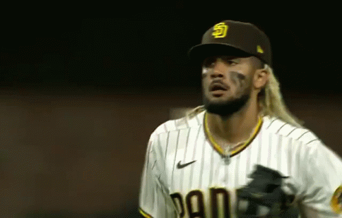 Long-Haired Baseball Player in Hat and Striped Shirt