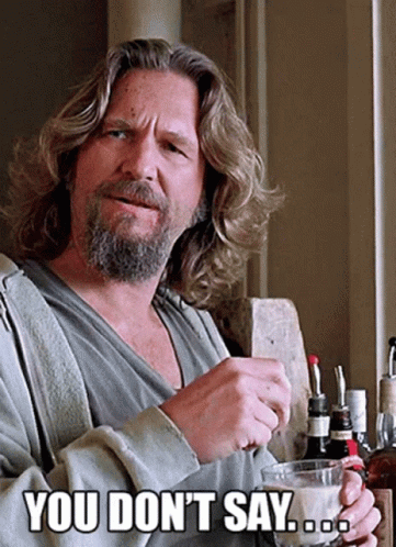 Long-Haired Bearded Man Holding Coffee Says You Don't Say