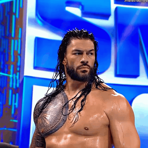 Long Haired Bearded Man in Front of Large S