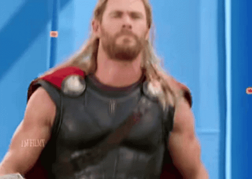 Long Haired Bearded Man in Superhero Costume Blue Wall