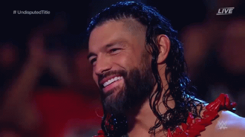 Long Haired Bearded Man Smiling in Red Outfit