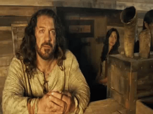 Long Haired Bearded Man With Woman Behind