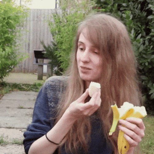 Long Haired Girl Eating Banana GIF