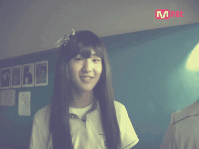 Long-Haired Girl Smiling at Mnet Sign