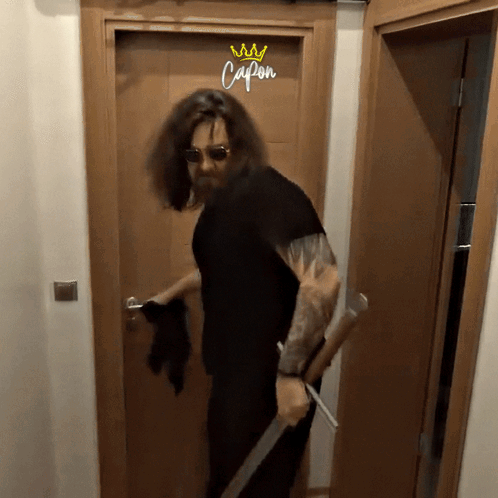 Long Haired Man Holding Sword At Capon Door GIF