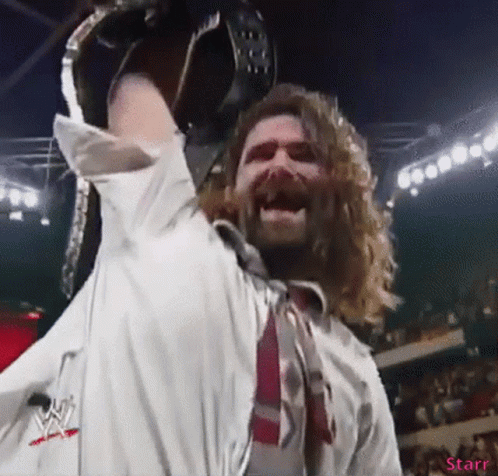 Long-Haired Man Holding Wrestling Belt