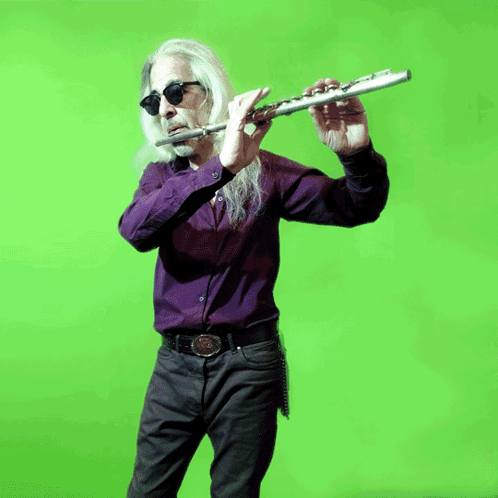 Long-Haired Man in Sunglasses Playing Flute