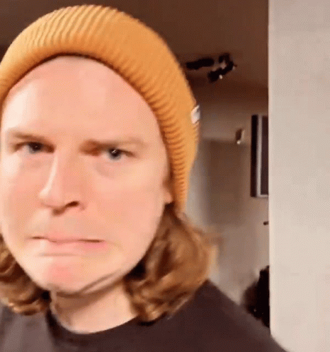 Long Haired Man in Yellow Beanie Funny Face