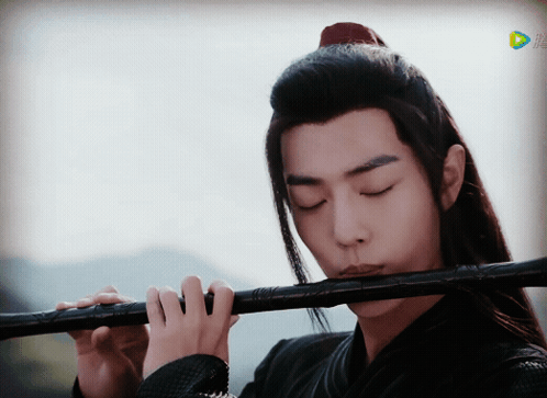 Long-Haired Man Playing Flute Before TV Saying Play GIF