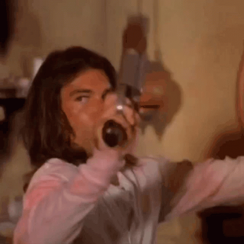 Long-Haired Man Screaming With Bottle in Mouth