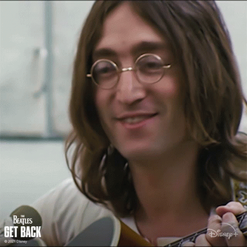 Long Haired Man Smiling Holding Guitar Disney+ Logo GIF