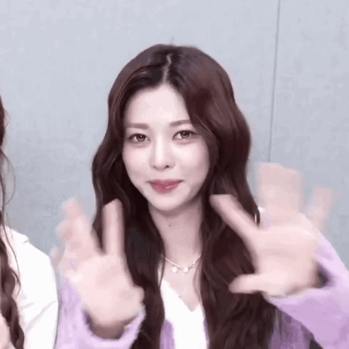 Long Haired Woman in Purple Sweater Giving Peace Sign