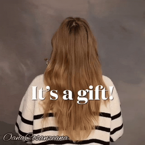 Long Haired Woman in Striped Sweater Saying It's a Gift