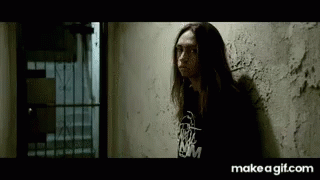 Long Haired Woman Leaning Wall Black Shirt NM GIF