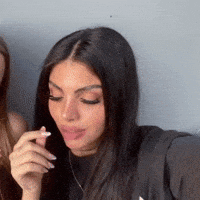 Long-Haired Woman Smoking Cigarette Another Woman Watching