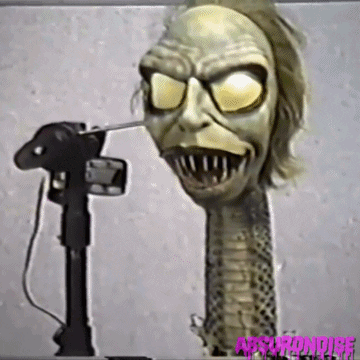 Long-Necked Monster Statue Being Photographed