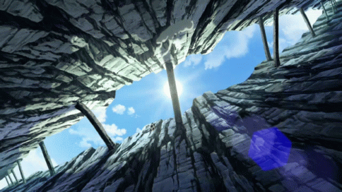 Looking Up At A Blue Sky Through A Hole In The Rocks GIF
