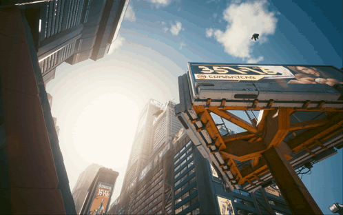 Looking Up At A City Skyline With A Billboard That Says Condoms On It GIF