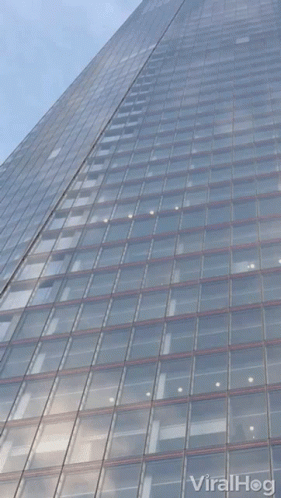 Looking Up At A Tall Building With Viralhog Written On The Bottom Right GIF