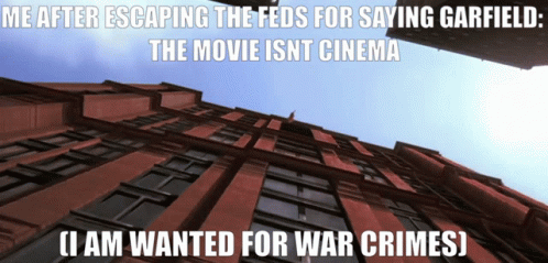 Looking Up At Brick Building Saying Me After Escaping The Feds For Saying Garfield The Movie Isn't Cinema GIF