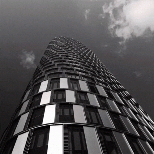 Looking Up At Tall Building With Cloudy Sky GIF