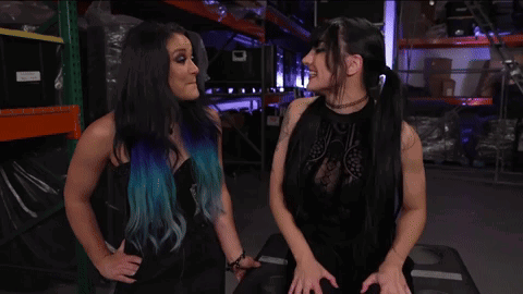 Lyra Valkyria And Tatum Paxley Are Standing Next To Each Other In A Warehouse GIF