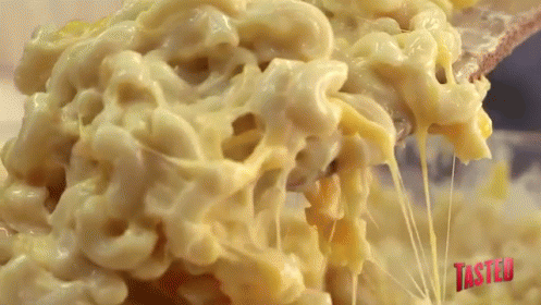 Macaroni And Cheese Is Being Scooped Out Of A Bowl GIF