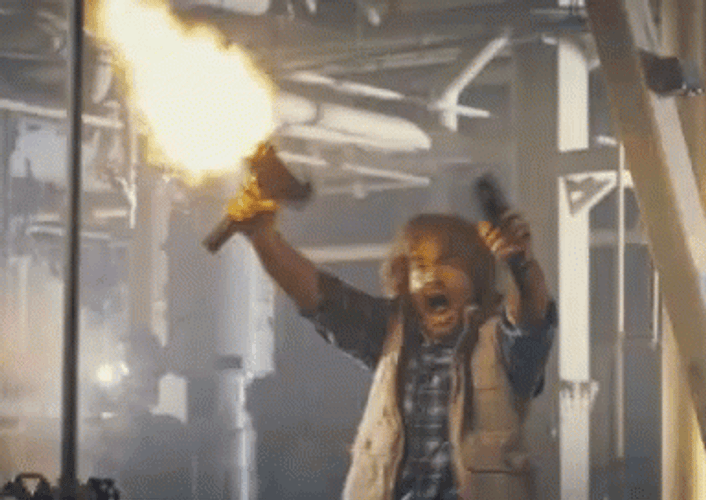 Macgruber Holding Gun While Shooting GIF