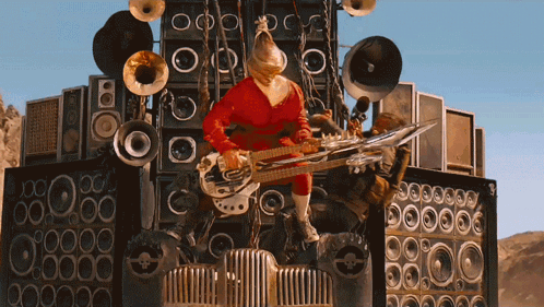 Mad Max Fury Road Doof Warrior's Guitar Used As Armor GIF