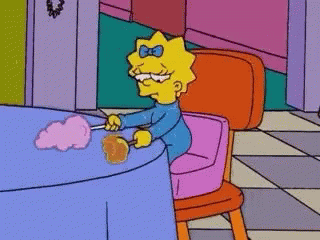 Maggie Simpson Is Sitting In A Pink Chair Next To A Table With Cotton Candy . GIF
