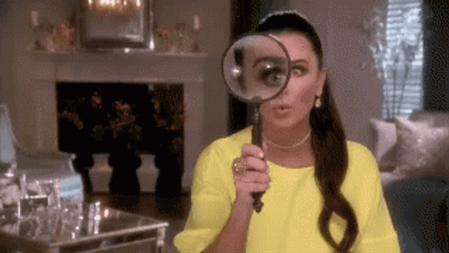 Magnifying Glass Amazes Yellow Lady GIF
