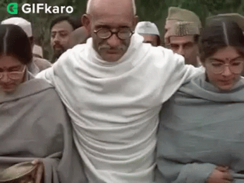 Mahatma Gandhi Walking Crowd White Shirt Glasses GIF