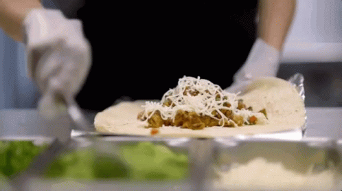 Making Burrito With Meat and Cheese