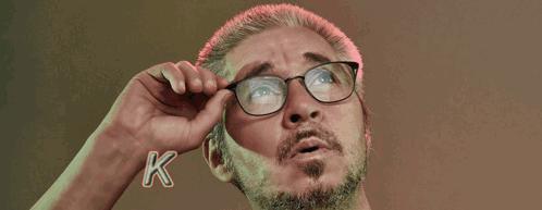 Man Adjusting Glasses in Front of Ko