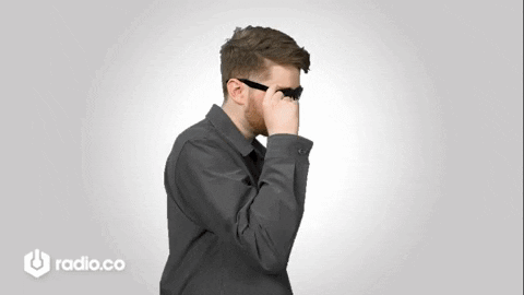 Man Adjusting Sunglasses in Front of Radio.co