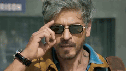 Man Adjusts Sunglasses By Prison Sign GIF