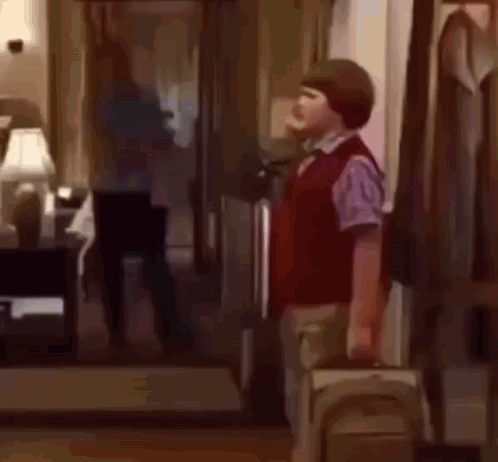 Man and Boy in Living Room Boy Carrying Suitcase