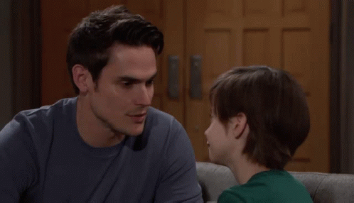 Man And Boy Looking At Each Other On Couch GIF