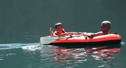 Man And Child On Raft In Water GIF