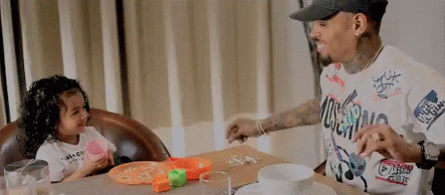 Man and Girl Eating Pizza and Playing With Toys