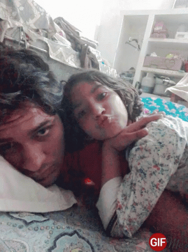 Man And Girl Lying On Bed GIF