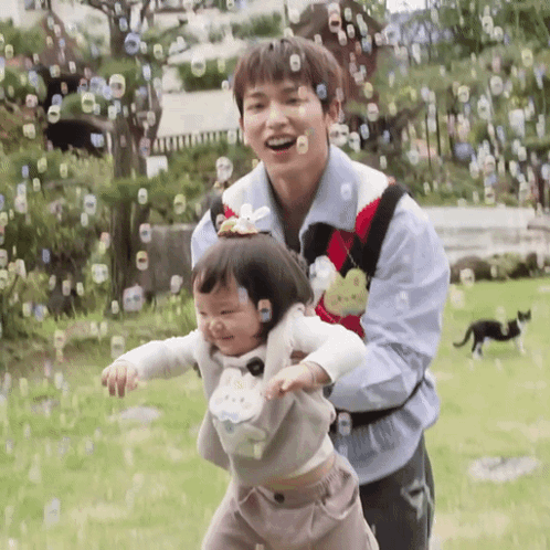 Man and Girl Playing With Soap Bubbles