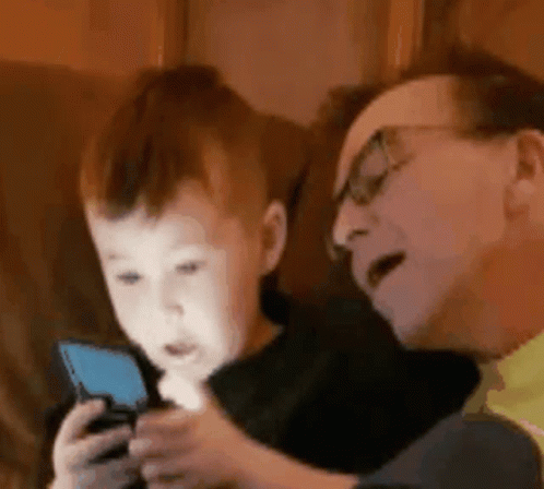 Man and Little Boy Playing With Cell Phone