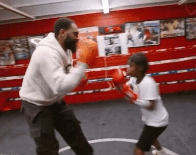 Man and Little Girl Boxing in Ring