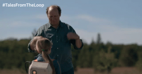 Man and Little Girl Standing in Field with #TalesFromTheLoop