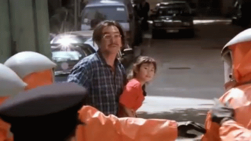 Man and Little Girl Walking Past Orange Jacket Group