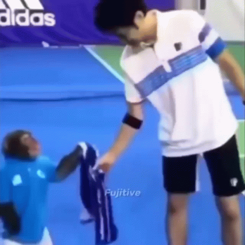 Man and Monkey on Tennis Court
