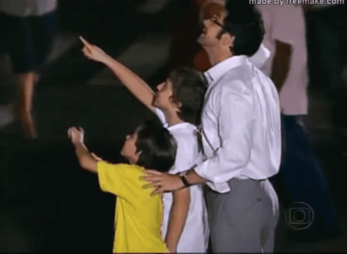 Man and Two Children Looking Up Made by Freemake.com