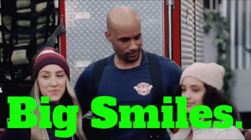 Man And Two Women By Fire Truck Saying Big Smiles GIF